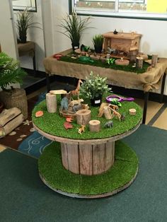 a table that has some plants on it in the middle of a room with other decorations