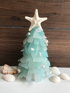 a christmas tree made out of sea glass and seashells