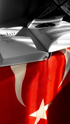 an open book sitting on top of a flag