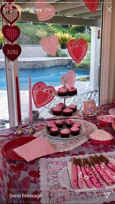 valentine's day dessert table with cupcakes and cookies