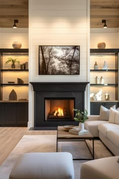 a living room filled with furniture and a fire place in the middle of a room