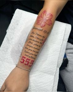 a person with a tattoo on their arm that has the number 553 written on it