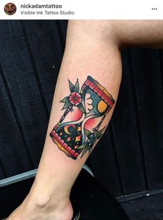 a woman's leg with a tattoo on it that has a clock and flowers