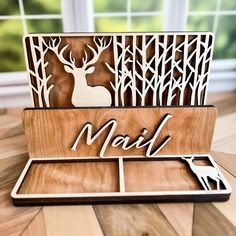 a wooden box with a deer cut out of it and the word mail on top