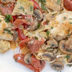 a white plate topped with pasta and meat covered in mushrooms, tomato sauce and parmesan cheese