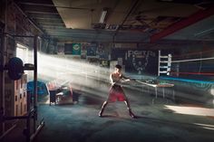 a woman is hitting a tennis ball with a racquet in an empty room