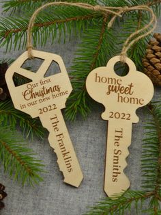 two wooden key ornaments hanging from a christmas tree