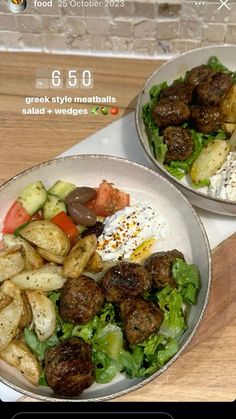 two bowls filled with meatballs and vegetables on top of a wooden table next to a brick wall