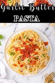 a white plate topped with pasta covered in tomato sauce and garnished with parmesan cheese