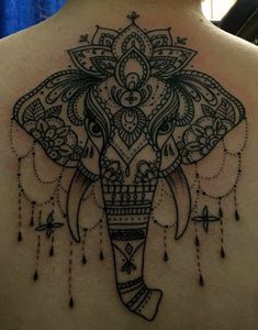 an elephant tattoo on the back of a woman