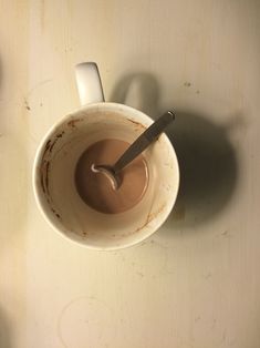 a cup of coffee with a spoon in it