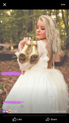 a woman in a white dress holding two golden bells