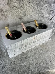 three wine glasses are lined up on a table with two champagne flutes in the middle