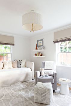 a living room filled with furniture and windows