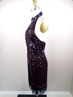 "This is an EXQUISITE vintage cocktail dress beautifully detailed and hand embellished with glass beading. It's in excellent condition! Bust - 33\" Waist - 27\" Hips - 38\" Length - 36-41\" Tag Size - Medium This dress comes from a pet-free and smoke-free home. If you would like more info or have any questions, please don't hesitate to ask!" Glamorous Hand-embellished Cocktail Evening Dress, Glamorous Hand Embellished Cocktail Evening Dress, Festive Embellished Cocktail Evening Dress, Glamorous Beaded Cocktail Dress, Beaded Sleeveless Sequin Dress For Formal Occasions, Sleeveless Beaded Sequin Dress For Formal Occasions, Fitted Evening Dress With Beaded Fringe, Hand Embellished Sleeveless Party Dress, Formal Sleeveless Sequin Dress With Beads