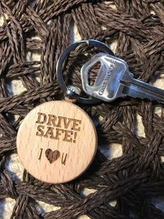 a wooden keychain with the words drive safe on it and a pair of scissors