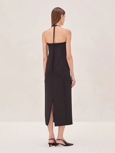 Introducing the Sezane Midi Dress—a modern piece with a sleek halter neckline, accentuated by a distinctive gold square detail. This midi dress features a streamlined silhouette that falls elegantly, offering a clean and contemporary look. Perfect for both day and evening, the Sezane Midi Dress is versatile in its simplicity, allowing for easy styling whether dressed up with heels or kept minimal. A true go-to for a polished and effortless appearance. Sezane Dress, Halter Neckline, Black Dress, Dress Up, Midi Dress, Sleek, Square, Heels, Dresses