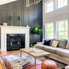 a living room with gray walls and white furniture