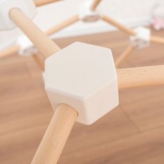 a close up view of a wooden bed frame with white plastic cubes on it