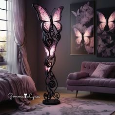 a floor lamp with pink butterflies on it next to a purple couch and chair in front of a window