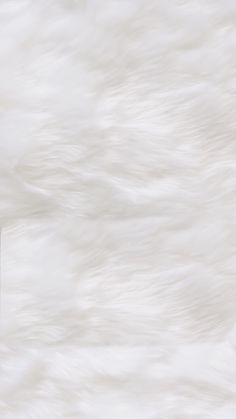 a white fur textured wallpaper with a phone on it