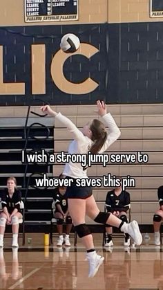 a volleyball player jumping up to hit the ball