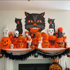 a mantle with pumpkins and black cats on it