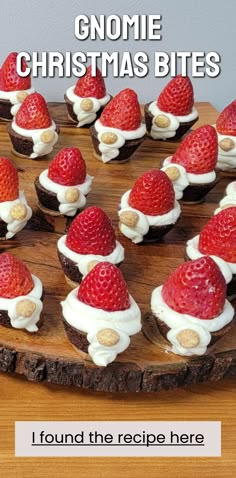 there is a wooden plate with some strawberries on it and the words gnome christmas bites