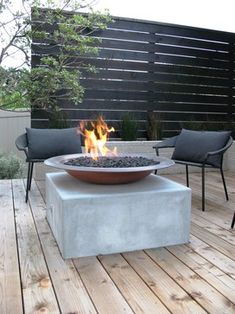 a fire pit sitting on top of a wooden deck