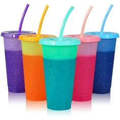 four different colored cups with straws in them