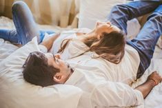 a man and woman laying in bed together