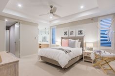 a bedroom with white walls and carpeted flooring