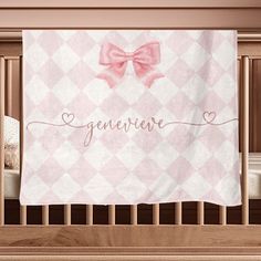 a baby crib with a pink and white blanket on it