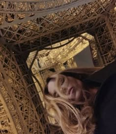 a woman standing in front of the eiffel tower with her face close to the camera