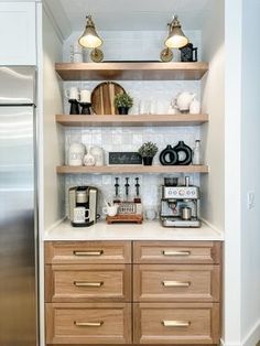 a kitchen with open shelving and coffee maker