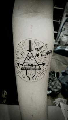 a tattoo on the leg of a person with an all seeing triangle and words above it