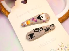 Get spooky with these hand embroidered barrettes. Each hair clip is made of linen and is hand embroidered by myself with high quality DMC cotton threads. Perfect for a bridal shower gift, birthday or anniversary gift!      This listing is for made-to-order hair clips in the charming Halloween themed design. You will received 2 clips as a part of this set.       As each item is hand embroidered and sewn, processing time should be taken into consideration as well as slight variations in size or design. Colors may vary on different monitors and screens. Please feel free to reach out to me for custom designs and a personalized listing can be made for you.      Product details:    - Material: linen    - Embroidery : 100% cotton mouline (DMC)    - Size : approx 5 cm (2 in) Embroidery Hair Clips, Christmas Embroidery Hair Clip, Hand Embroidered Hair Clip, Embroidery Bows Hair Clips, Baby Barrettes, Halloween Hair Clips, Halloween Embroidery, Halloween Designs, Clip Ins