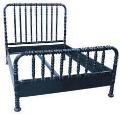 a black bed frame with wooden posts and spindles on the headboard, against a white background