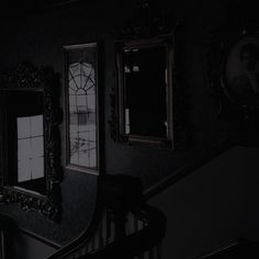 the stairs are dark and there is a mirror on the wall next to each other