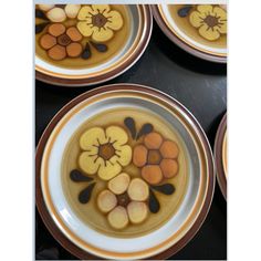 four plates with flowers painted on them