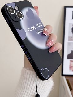 a woman holding up a phone case with hearts on it and the words flame blue loving