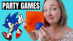 a woman holding an orange and blue object in front of her face with the words party games on it