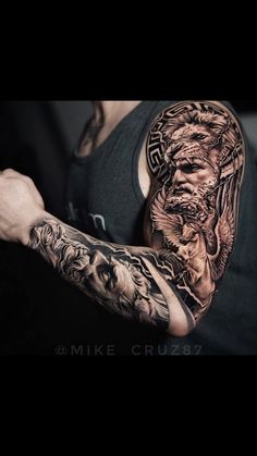 a man with tattoos on his arm and shoulder