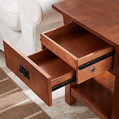 a wooden table with two drawers on each side and a white chair in the background