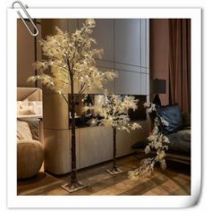 two tall trees with white lights in a living room