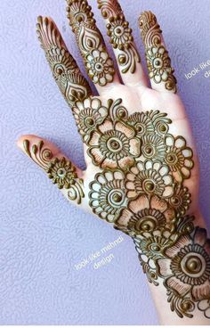 the hand is decorated with henna designs