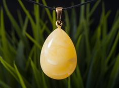 A fascinating handcrafted yellow landscape amber pendant will become not only an exquisite piece of jewelry, but also a true work of art. This unique piece, made from a piece of rare landscape amber of the highest quality, impresses with its unique patterns and elegant shape. Details: -Materials: natural amber -Metal: sterling silver, gold plated -Color: yellow  -Weight:7.9 g -Total length pendant: 4.5 cm  -Stone size length: 3.1 cm   -Stone size width: 2.5 cm   Amber is not just a beautiful stone, it is a treasure that holds the history of millions of years. It is formed from the sap of coniferous trees that lived millions of years ago. This process takes millions of years, making amber one of the oldest jewelry materials on Earth. Landscape amber is a special type of amber that contains Handmade Baltic Amber Pendant Necklace, Handmade Yellow Baltic Amber Necklace, Handmade Yellow Baltic Amber Necklaces, Handmade Baltic Amber Necklace In Yellow, Elegant Yellow Baltic Amber Necklaces, Baltic Amber Drop Jewelry In Amber, Teardrop Baltic Amber Necklace, Baltic Amber Drop Jewelry In Amber Color, Yellow Baltic Amber Jewelry For Gifts