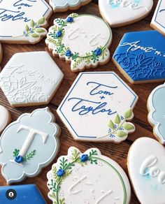 decorated cookies with blue and white frosting are arranged on a table