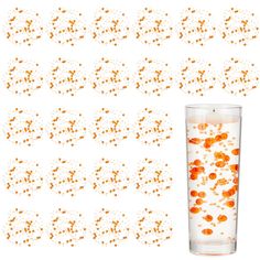 an orange liquid in a glass filled with water next to small circles of orange dots