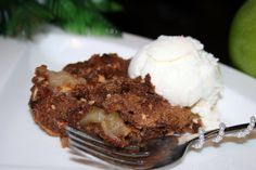 an apple crisp with ice cream on a white plate